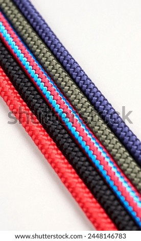 Colorful rope twisted on a white background. Colorful rope coil, close-up