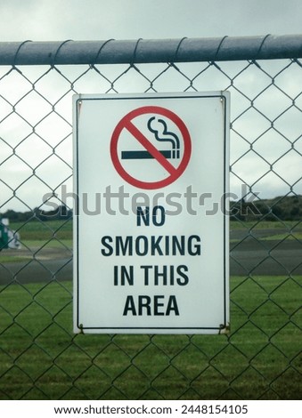 No smoking sign on a fence