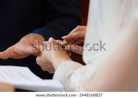the intimate moment as the bride places a wedding ring on the groom's finger, symbolizing eternal love
