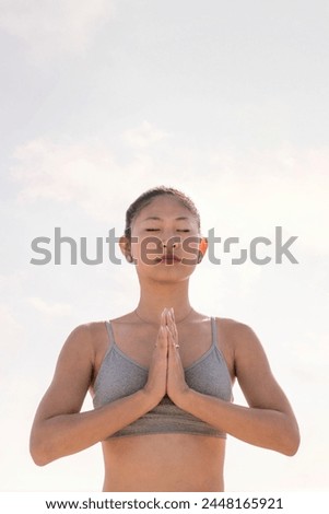 asian woman practicing yoga in pray position