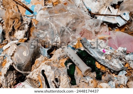 Plastic waste and fabric scraps that are difficult to decompose Being abandoned in public places is an environmental problem in urban communities. Industrial zones in 3rd world countries
 Royalty-Free Stock Photo #2448174437