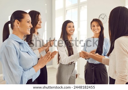 Happy smiling business women achievement success sharing, girls applauding at meeting discussion or training, female group team office interaction. Colleague gathering for coaching to instruct, guide Royalty-Free Stock Photo #2448182455