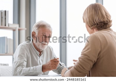 Senior man with a pen and document signing contract in doctor's office, senior patient making a health insurance deal