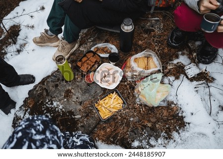 camping in the forest, breakfast in nature, hiking in the forest, food lying on a rock, sausage, bread, thermos with tea. High quality photo