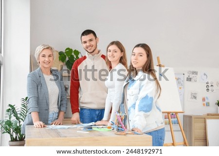 Young students with teacher during lesson in art school