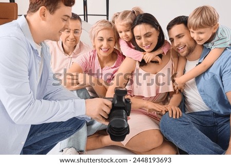 Big family looking at taken pictures in studio