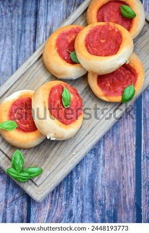 Mini margherita napoletan pizza with tomato,mozzarella  cheese and basil,  on wooden background