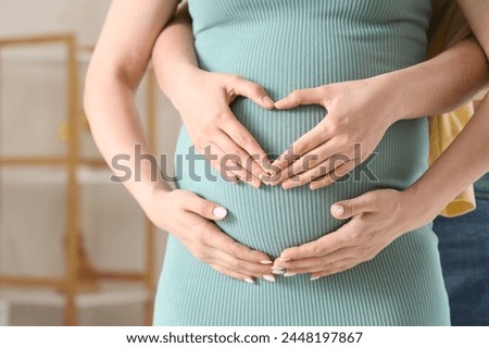 Young pregnant lesbian couple hugging at home, closeup Royalty-Free Stock Photo #2448197867