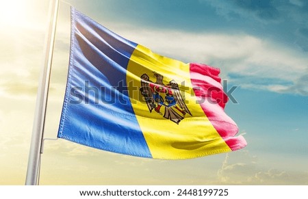 Moldova national flag waving in beautiful sky.