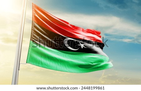 Libya national flag waving in beautiful sky.