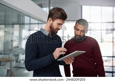 Male designers, talking and tablet in office for career, web project or occupation review online for email feedback. professional creative men or editor and tech for digital report research on mockup