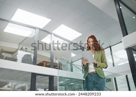 Low angle, business woman and tablet in office for career, web project or occupation review online for email feedback. Young female person or editor and tech for digital report research on mockup