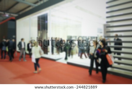 People visit a trade show. Intentionally blurred post production.