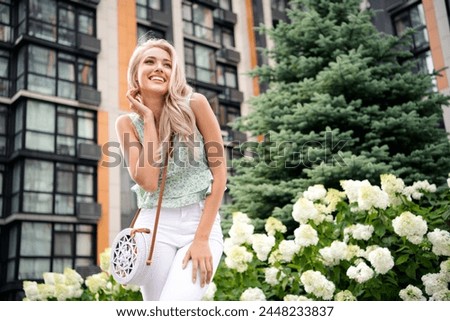Photo of cheerful lovely cute pretty girl dressed in stylish clothes rented apartment in downtown modern residence warm spring day