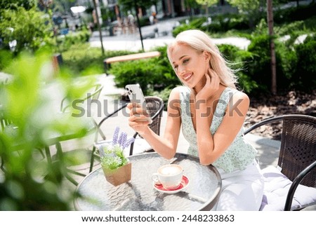 Photo of pretty cute shiny positive girl spending free time break pause after work in cafe summer terrace ideal day ending