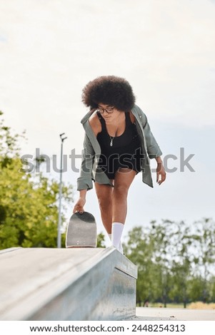 A young African American woman with curly hair glides on a skateboard in a skate park.