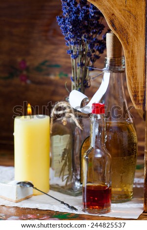 Vintage still life with pharmacy vials, dried calendula and a candle in an old drugstore
