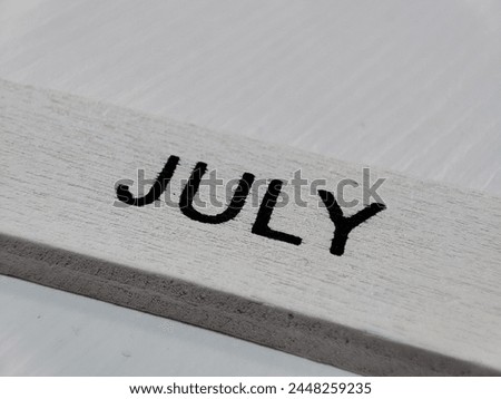 Wooden calendar blocks with summer months.  June July August