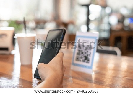 man use smartphone to scan QR code to pay in cafe restaurant with a digital payment without cash. Choose menu and order accumulate discount. E wallet, technology, pay online, credit card, bank app.