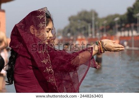 young devotee praying for holy god after bathing in holy river water at morning from flat angle Royalty-Free Stock Photo #2448263401