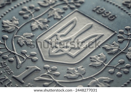 Macro photo of a Ukrainian coin. Ukrainian coat of arms trident on a coin