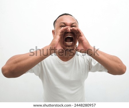 Adult asian man shouting announcing something