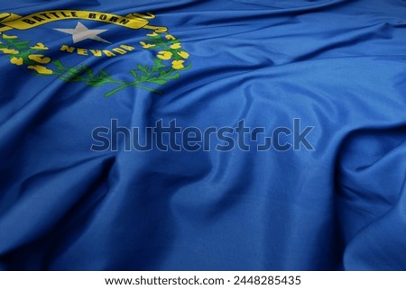 waving colorful flag of nevada state. macro shot