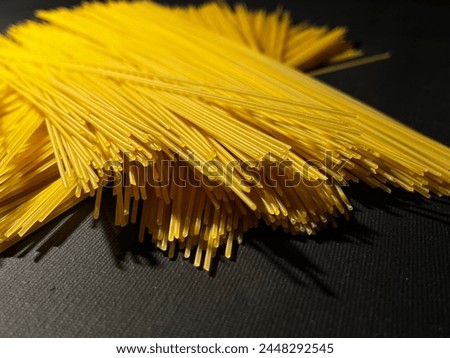 Dry spaghetti lies on a black background. High quality photo