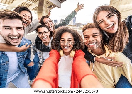 Happy multiracial friends taking selfie pic outdoors - Group of young people smiling together at camera on city street - University students having fun in college campus - Youth community concept
