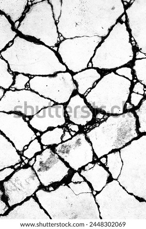 a black and white photo of cracked concrete, subsurface cracks. Royalty-Free Stock Photo #2448302069