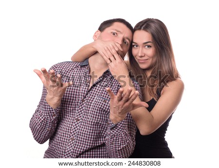 Portrait of a couple of people. relationship. family . quarrel . swearing. she covers his mouth with his hands 