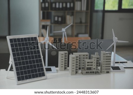 Close-up at tablet, Engineers pointing at tablet with their hands. To jointly design the use of renewable energy with wind and solar energy. Concept of using renewable energy.