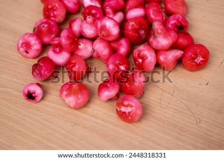 Water Guava jampu kai fruit in india. delicious fruit photo taken with wood surface