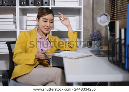 Attractive businesswoman sitting and stretching to relax in a chair in the office.