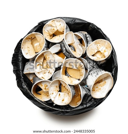 Top view a trash  bin filled with used paper cups, showing people drink too much coffee. They cost health issue and considering more sustainable option to minimize waste of single -use produtcs.  Royalty-Free Stock Photo #2448335005