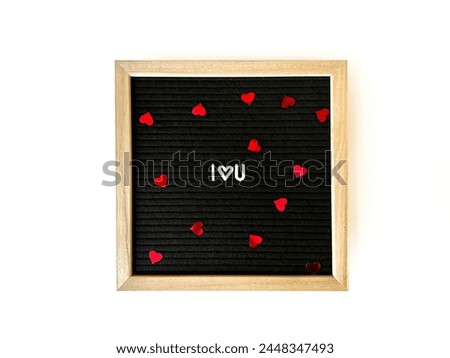 Black Letter board with spelled words I love you with confetti hearts. Love and Romance.