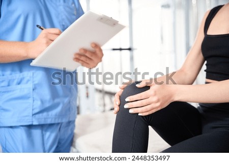 Doctor interviews a woman in a kinesiology clinic Royalty-Free Stock Photo #2448353497