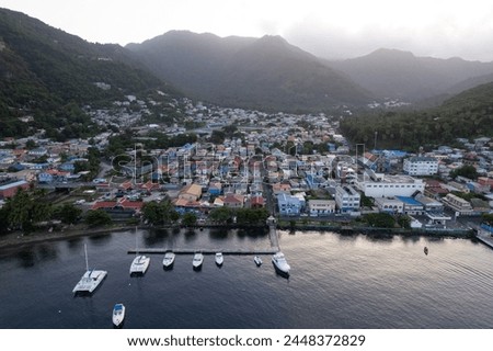 Aerial  top down view of the city of Soufriere with Pitons in the background.  Shot on a drone in the Caribbean on beautiful Saint Lucia island.  Colorful houses throughout the town.
