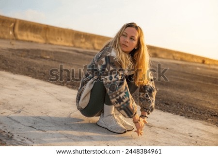 young sad poor woman seating alone at the street stressed and depressed