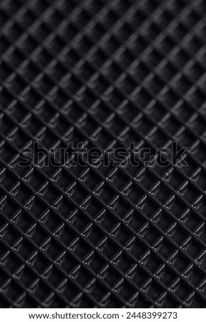 Close up of a black carbon fiber as a background. Macro