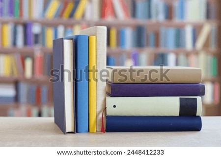 stack of books on wooden table in library, education, book