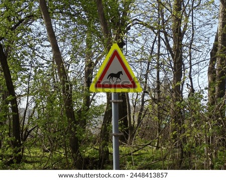 Horse warning sign on side of a trail in a forest in western Hungary 