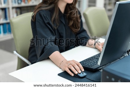 Woman working on computer in office, banking concept, stock photo