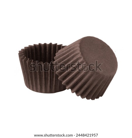 Brown paper baking forms for muffins isolated over white background, object photography, confectionery concept