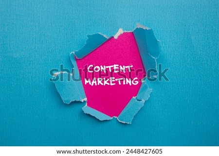 Content marketing words written on ripped blue paper with pink background. Conceptual content marketing symbol. Copy space.