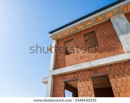 under construction hollow brick material apartment building, rough construction, ongoing building project, copy space Royalty-Free Stock Photo #2448430335