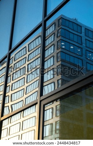 Glass facade of a modern office building in the city center Royalty-Free Stock Photo #2448434817