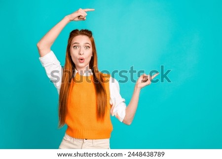 Photo portrait of pretty young girl point shocked empty space wear trendy orange knitwear outfit isolated on cyan color background