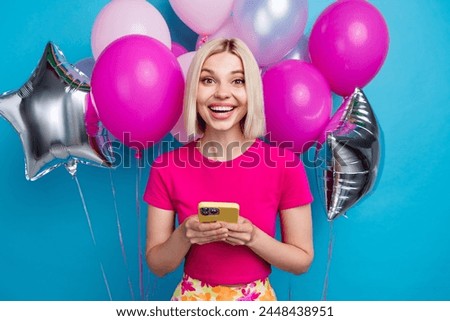 Photo portrait of attractive young woman air balloons hold device dressed stylish pink clothes isolated on blue color background