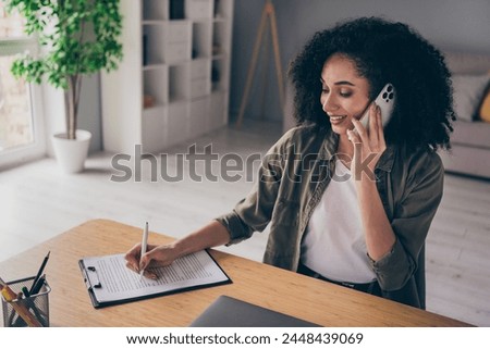 Photo of shiny pretty lady manager dressed shirt answering modern device writing list indoors workshop workplace workstation